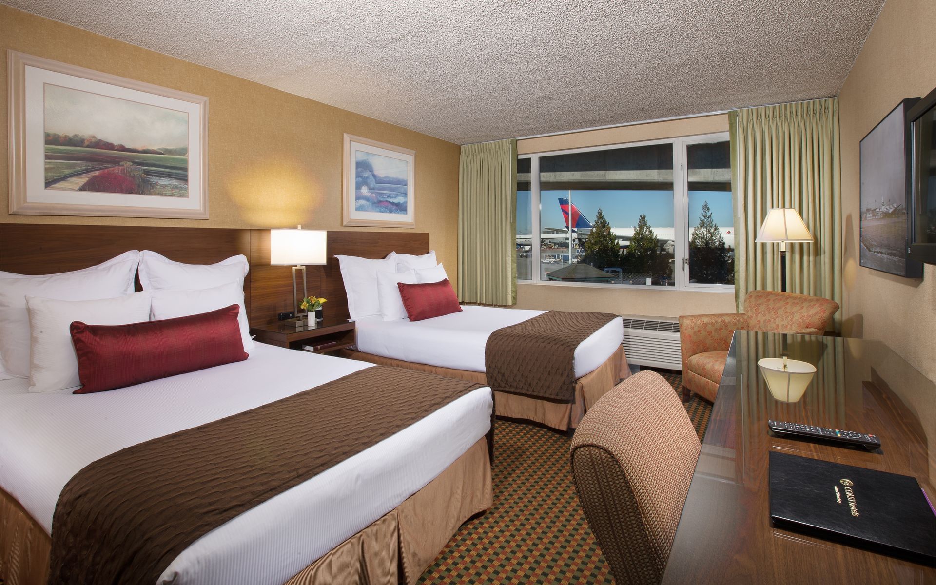 Two beds in hotel with view of airport