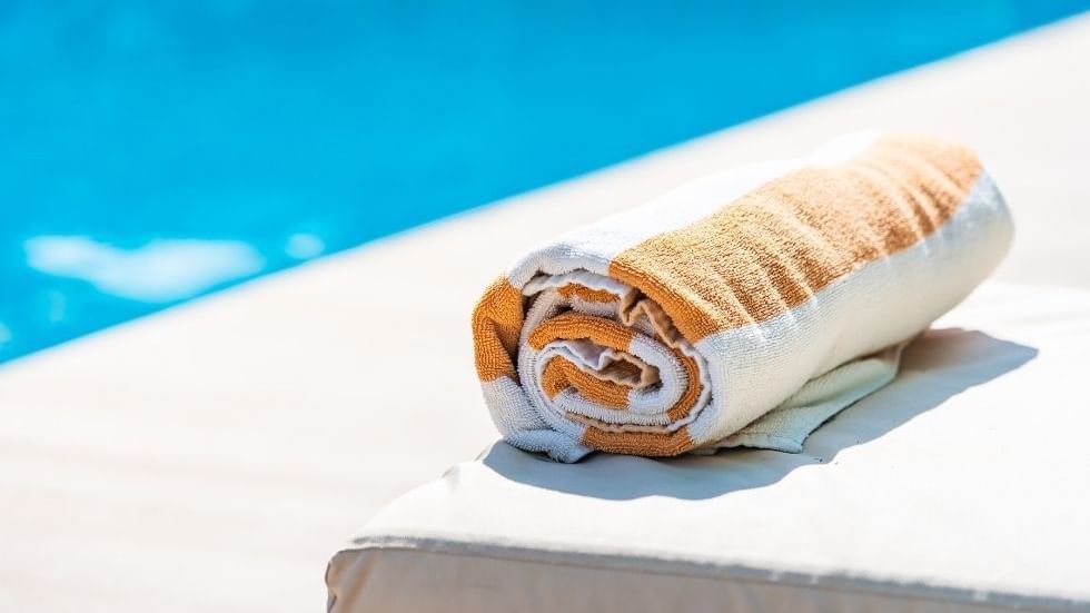 Rolled towel on a sun lounger by the pool at Sunway Hotel Big Box