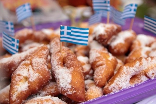 A close-up of fried food on a platter decorated with Greek flags for the Orlando Greek Fest.