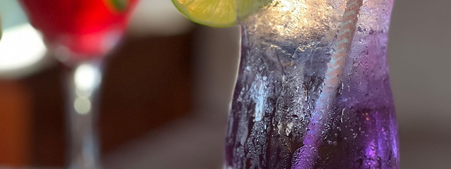 Two colorful drinks with straws and lime slices at Warwick Le Lagon Vanuatu in Efate
