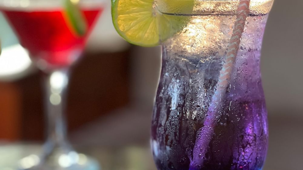 Two colorful drinks with straws and lime slices at Warwick Le Lagon Vanuatu in Efate
