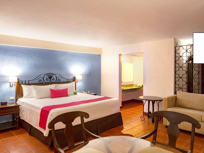 Bed & furniture in Junior Suite at Gamma Hotels