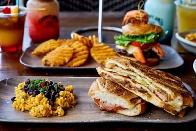 Burger, Cuban sandwiches, and waffles served with beverages in Sloppy Joe's at Bilmar Beach Resort