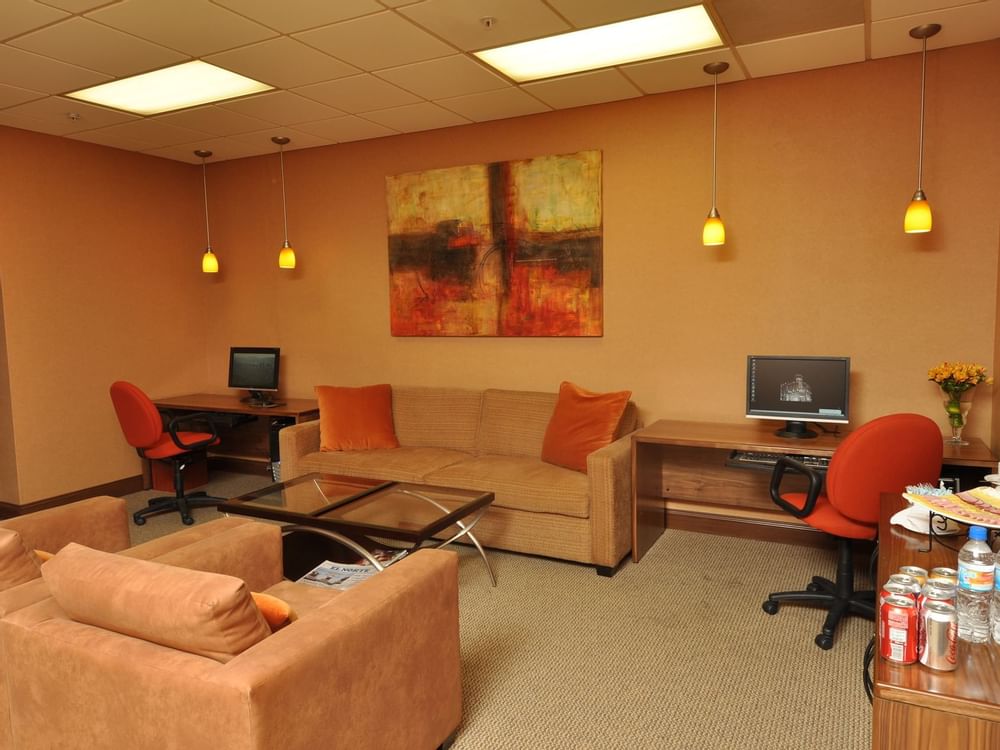 Sofas & 2 computers in Elipase Meeting Room at Gamma Hotels