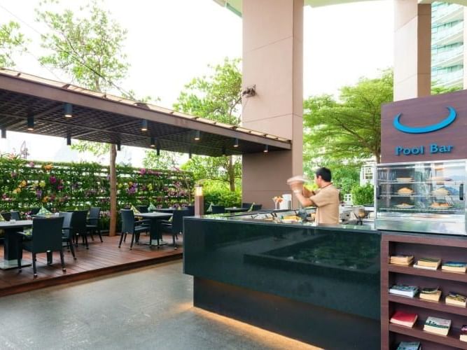 Bartender preparing cocktails in the Pool Bar, Chatrium Hotels