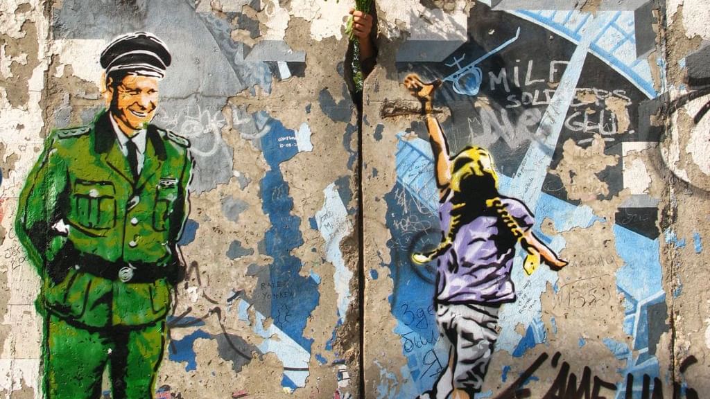 Wall art of a soldier looking at a kid near Hotel Berlin Berlin