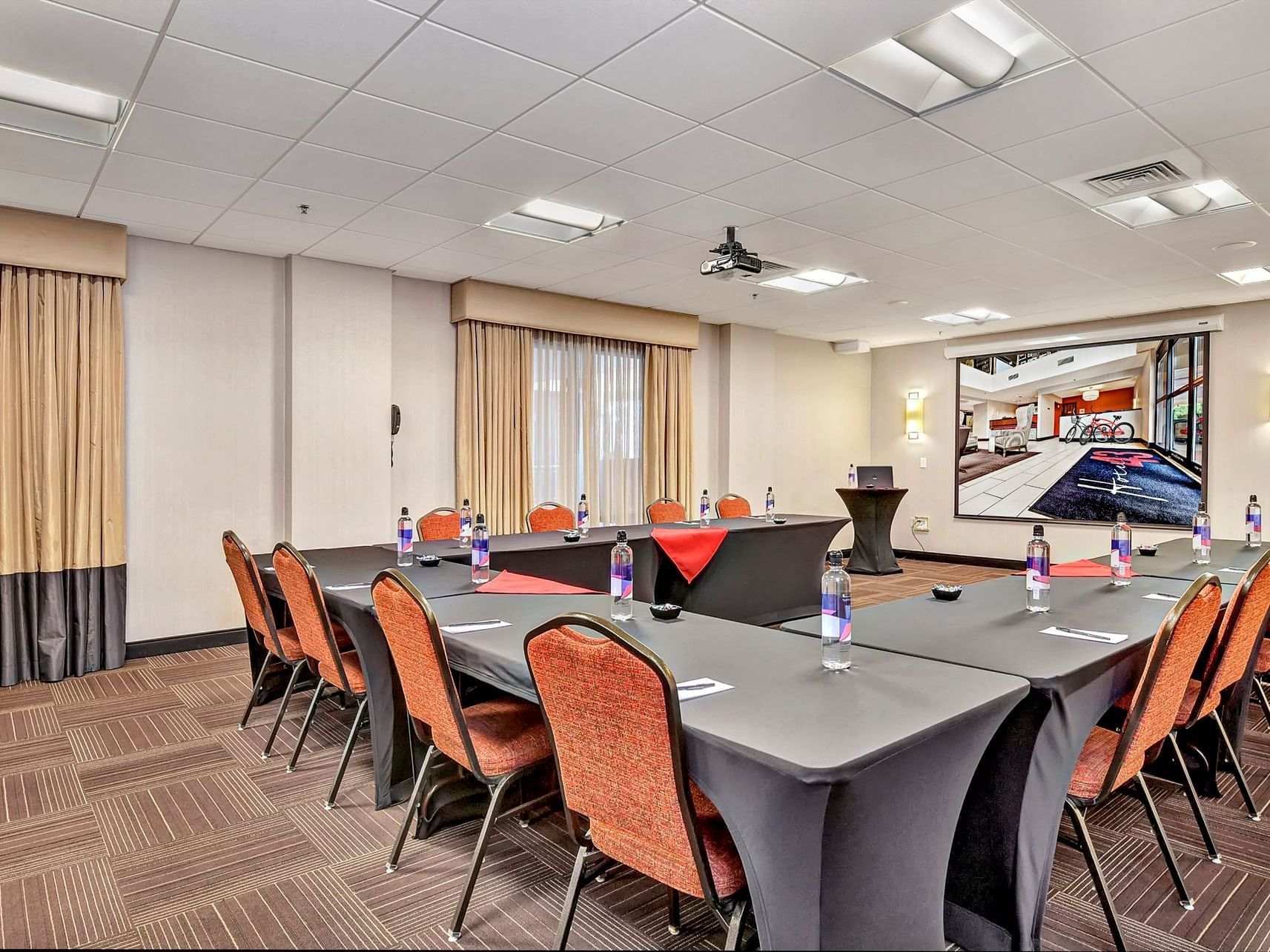 Arranged tables & chairs in a meeting room at Hotel 43