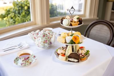 Spread of afternoon tea platter served with beverages in Pendray Tea House at Huntingdon Manor