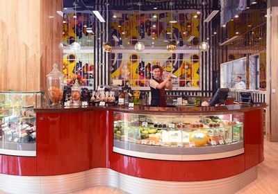 red display counter with barista shaking drinks