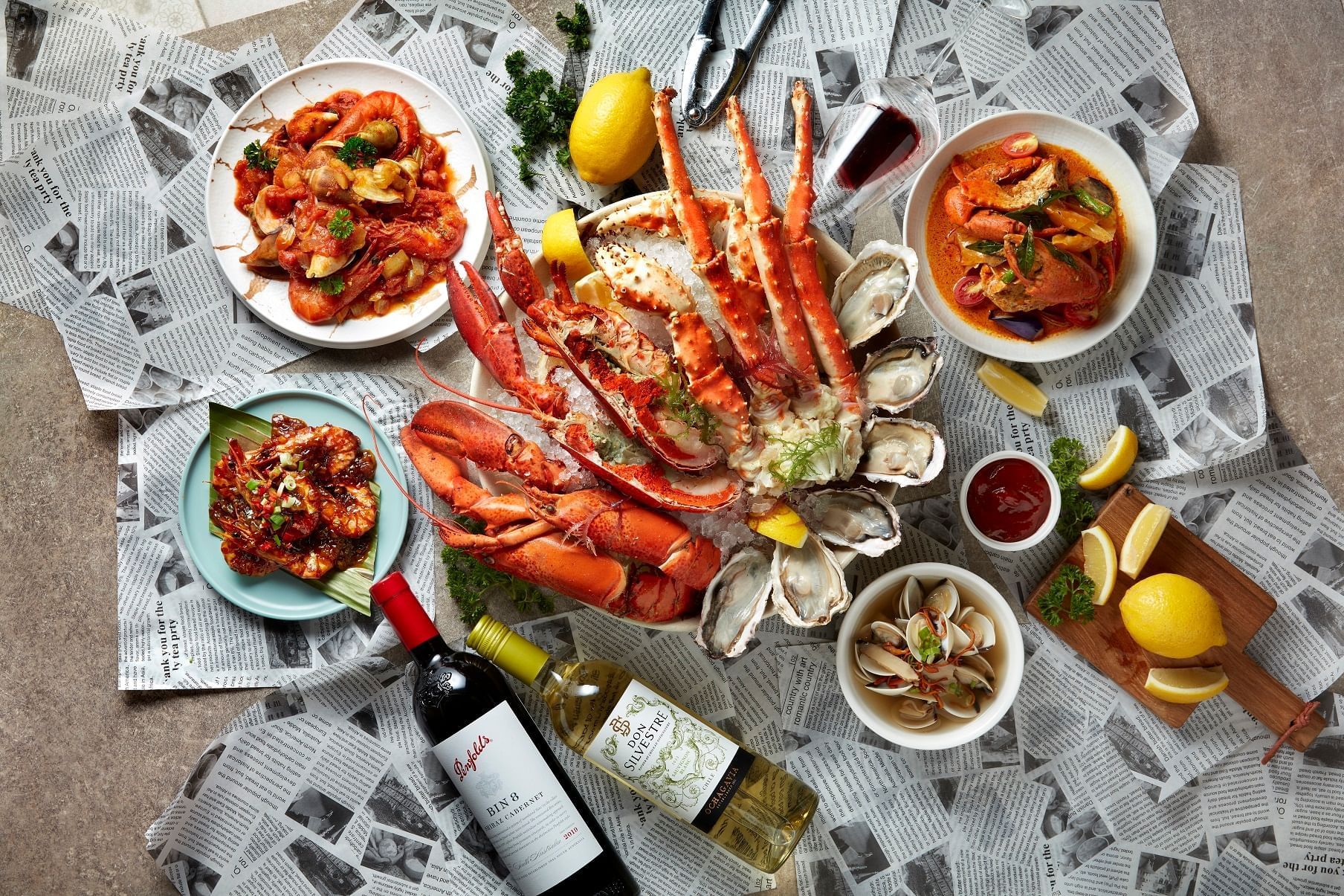Seafood dishes served with wine bottles at Paradox Singapore