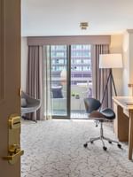 View of Accessible Deluxe Rooms by a balcony under a tripod lamp through an open doorway at Warwick Denver