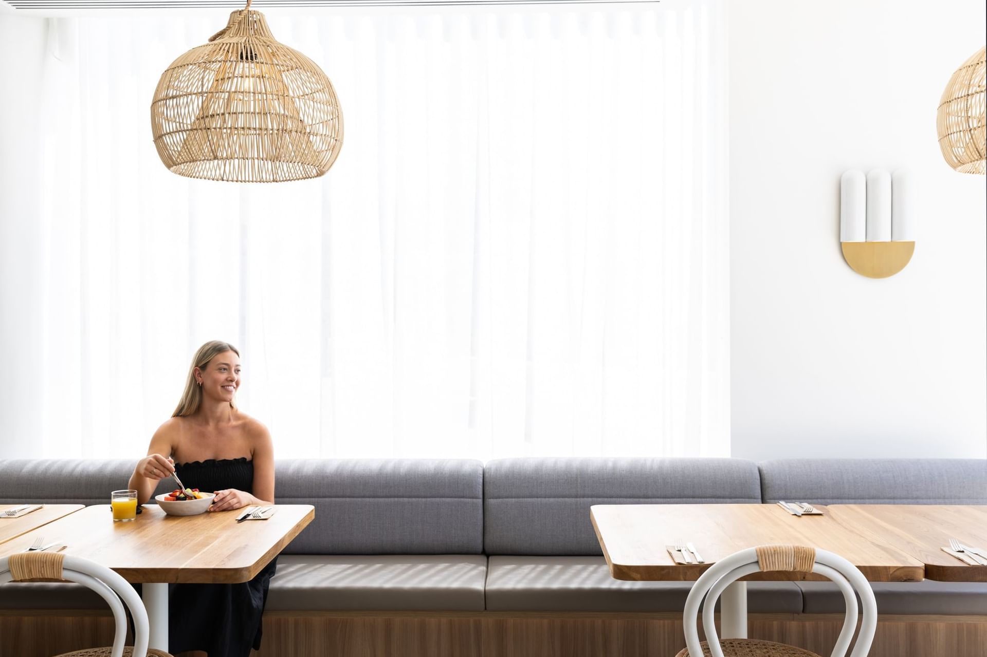 Woman in Dining Area | Novotel Sydney Brighton Beach