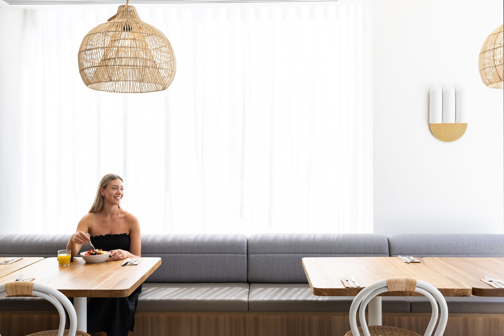 Woman in Dining Area | Novotel Sydney Brighton Beach