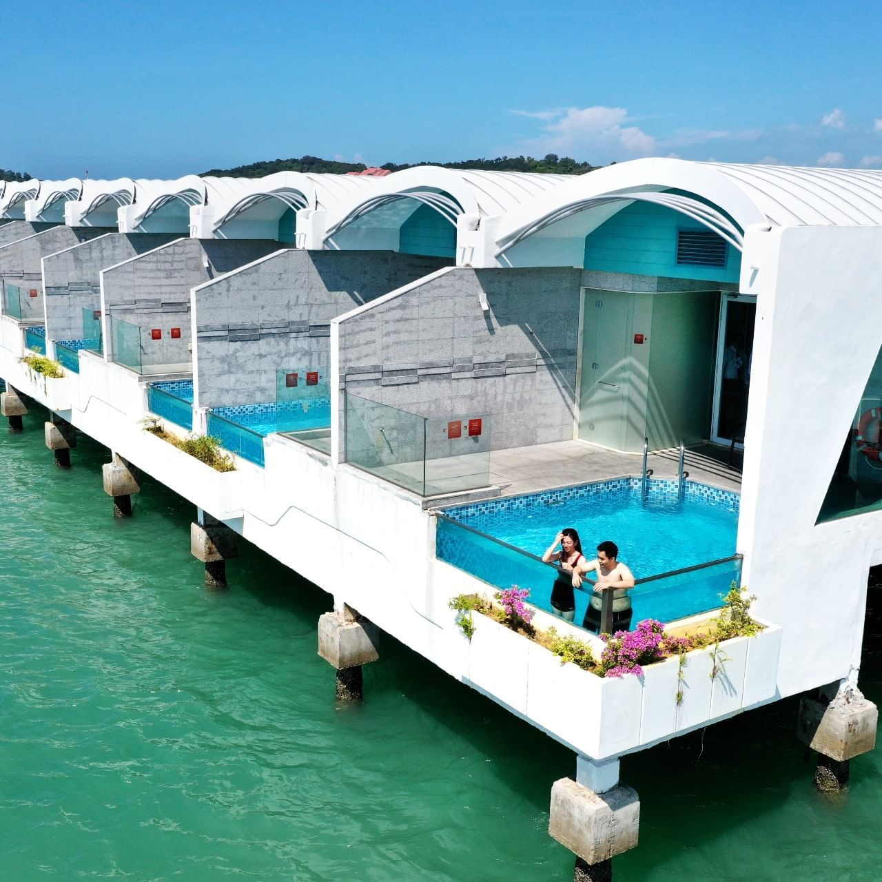 Couple relaxing by the private pool at Villa in Lexis MY