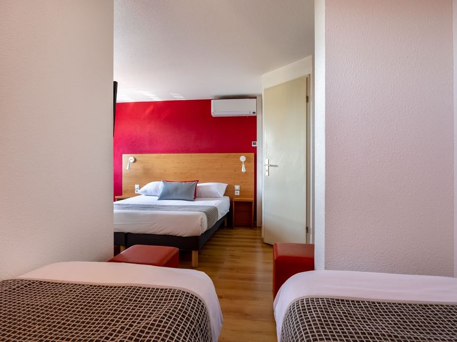 Beds in a room in Hotel Macon Sud at The Originals Hotels
