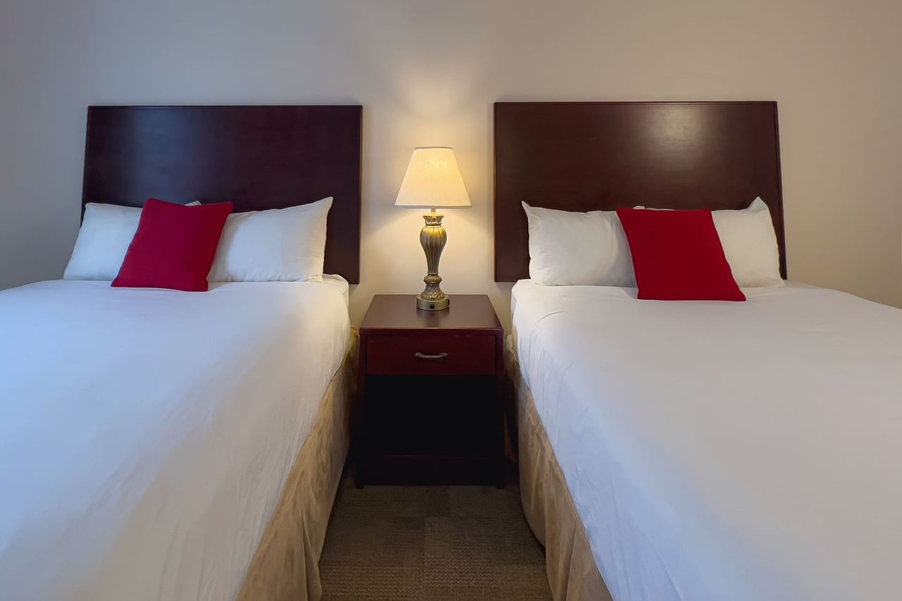 Guest room with two beds and lamp