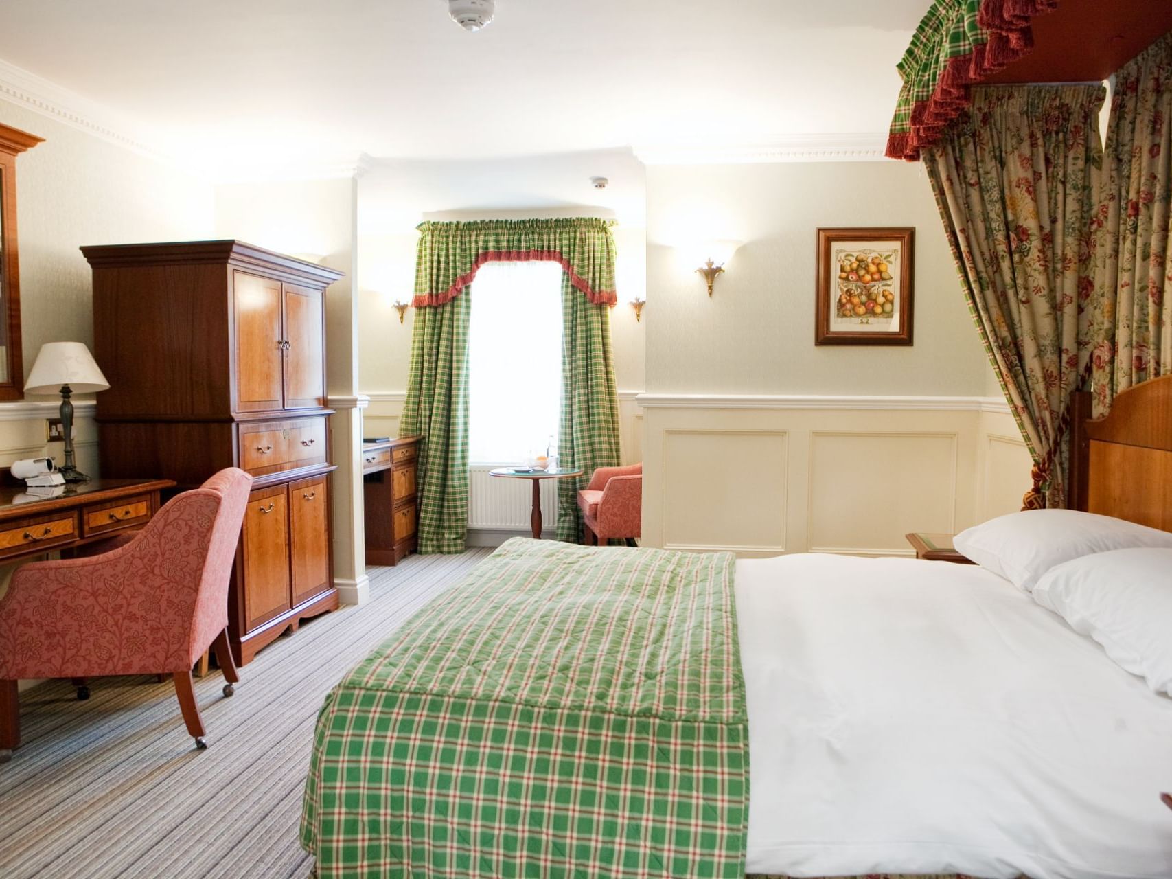Charming Brampton Lodge Executive Room at Marygreen Manor, with a four-poster bed, work area, and window seating