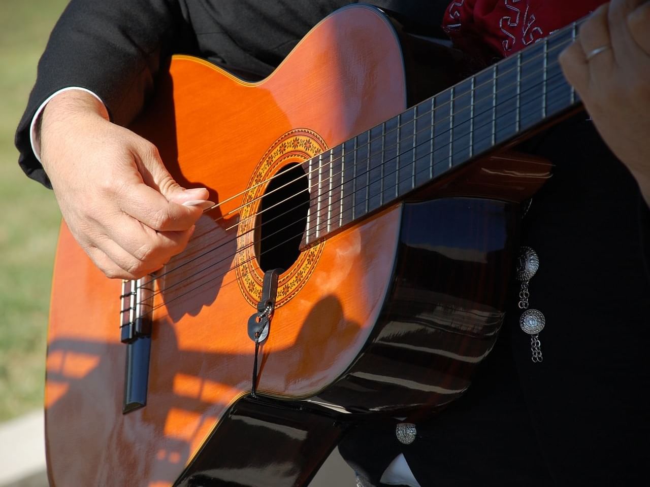 Musician playing a classical guitar during the concert by a musician, singer, and songwriter from Sonora at One Hotels