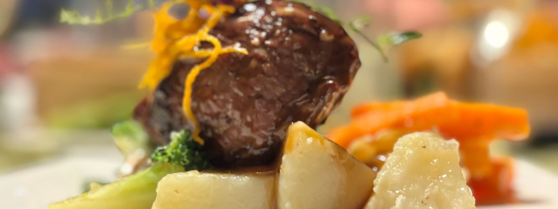 Meat, potatoes, and vegetables on a plate at Wild Ginger Restaurant & Bar in Efate at Warwick Le Lagon - Vanuatu