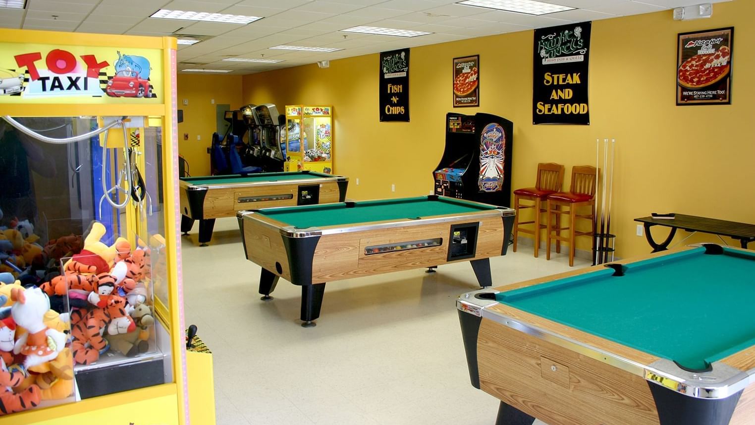 Game room with pool table and arcade games at Lake Buena Vista Resort Village & Spa