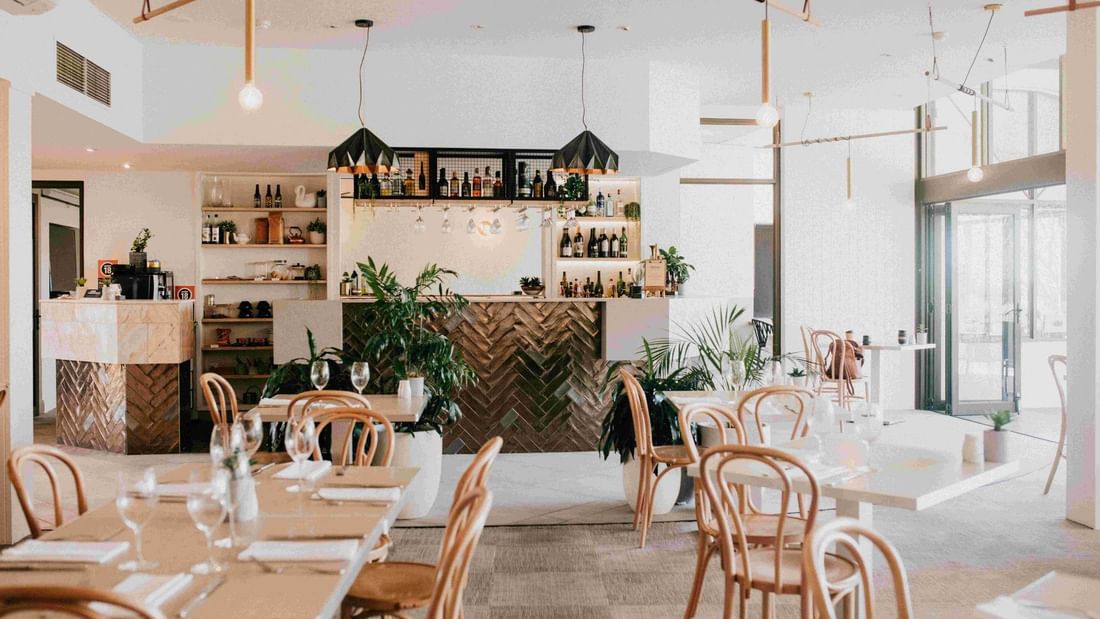 Interior of Madison Kitchen + Bar Restaurant with dining tables and bar at Mercure Charlestown in Charlestown.
