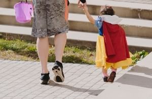 An adult and child enjoy Halloween festivities together 2023