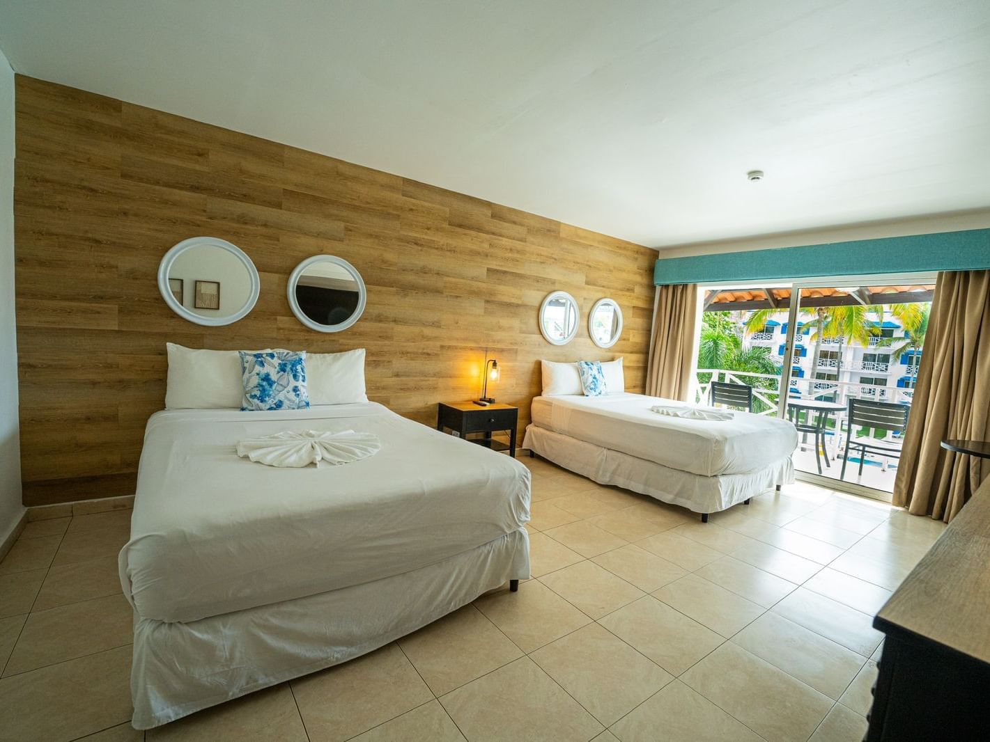 Pool view room with 2 double beds and a view of the pool and the giant slides at Playa Blanca Beach Resort