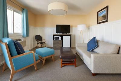 Cafe Queen Suite TV lounge with plush seating by the window at The Hotel Maria