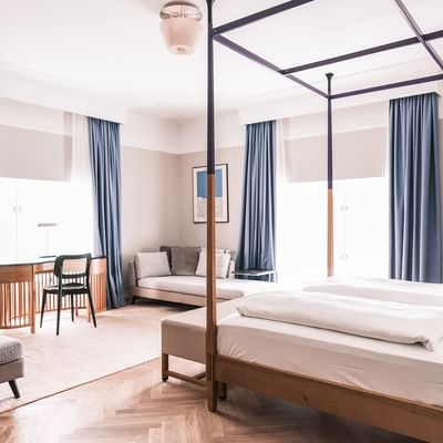 Large bed & lounge in Junior Suite at Falkensteiner Hotels