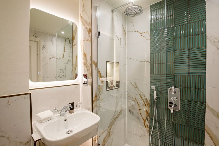 Bathroom featuring a vanity with mirror and a glass shower at The Capital Hotel, Apartments and Townhouse