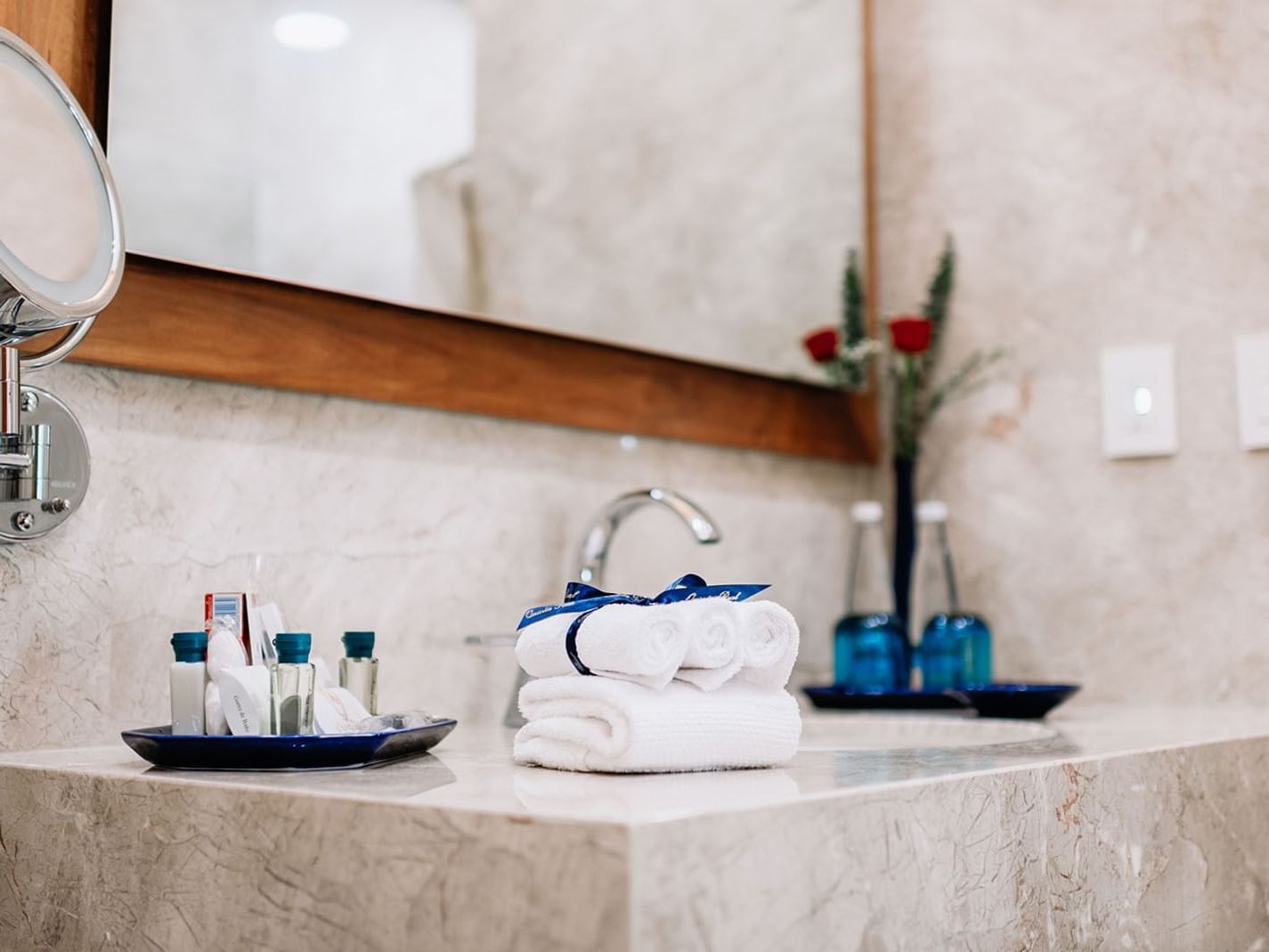 Bathroom counter with a large mirror and amenities in the Queen Novicia Suite at Quinta Real Oaxaca