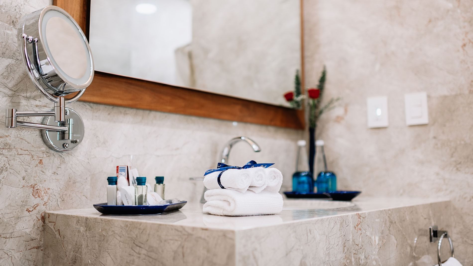 Bathroom counter with a large mirror and amenities in the Queen Novicia Suite at Quinta Real Oaxaca
