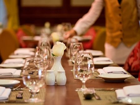 Close-up of a table with glassware arranged in L'auberge Restaurant at Warwick Doha