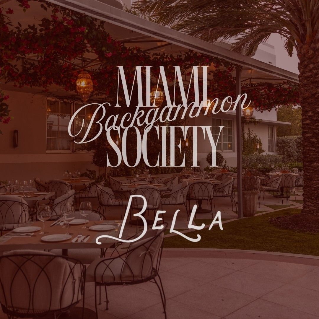 Outdoor dining patio with tables, chairs, palm trees, and hanging floral arrangements for The Backgammon Society at Bella.