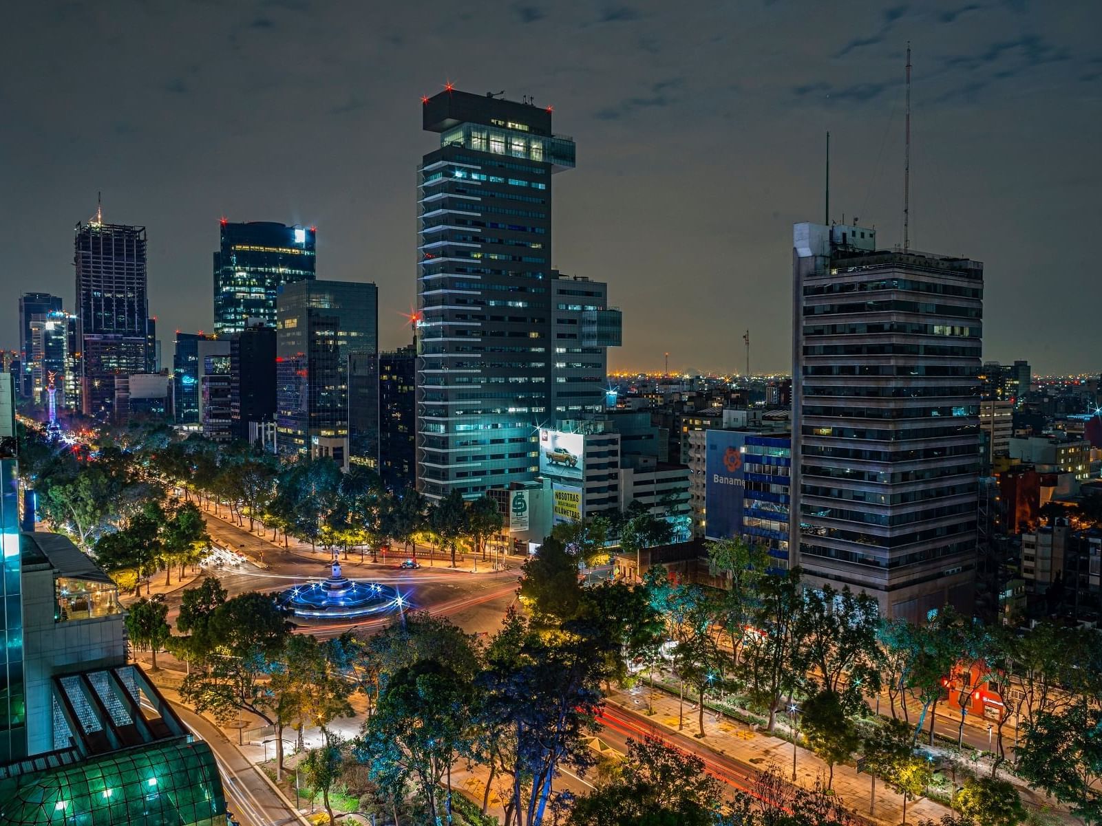 An Aerial view of the city at night near Marquis Reforma