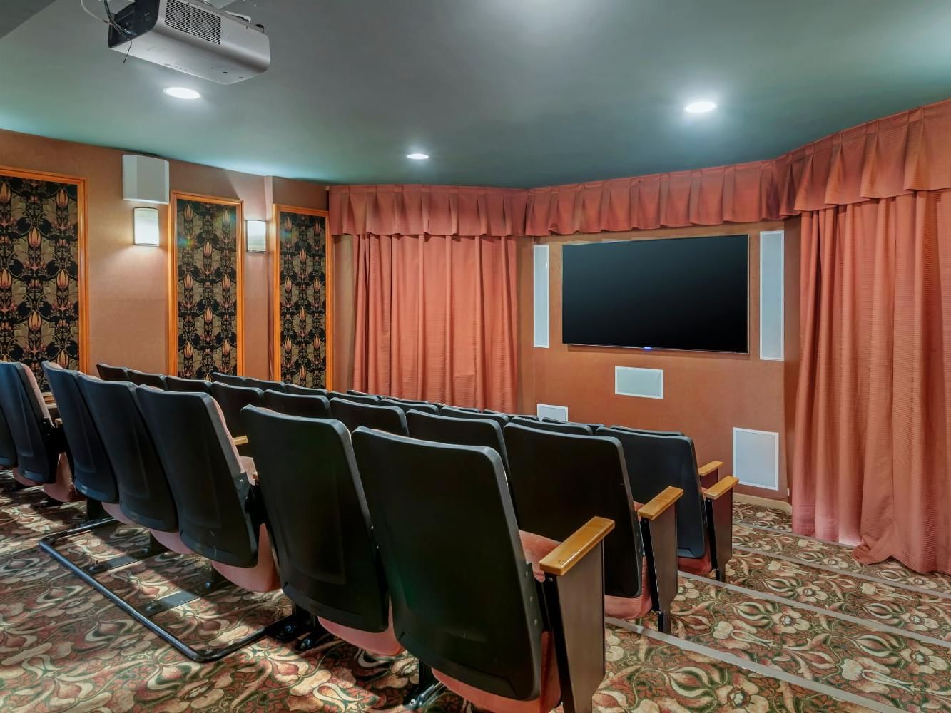 Spacious movie theatre with a multimedia projector & comfortable chairs at Meadowmere Resort