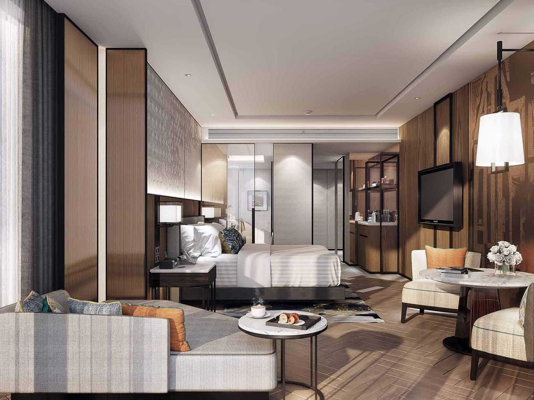 Bed & living area sofa in 2-Bedroom Suite at Eastin Grand Hotel