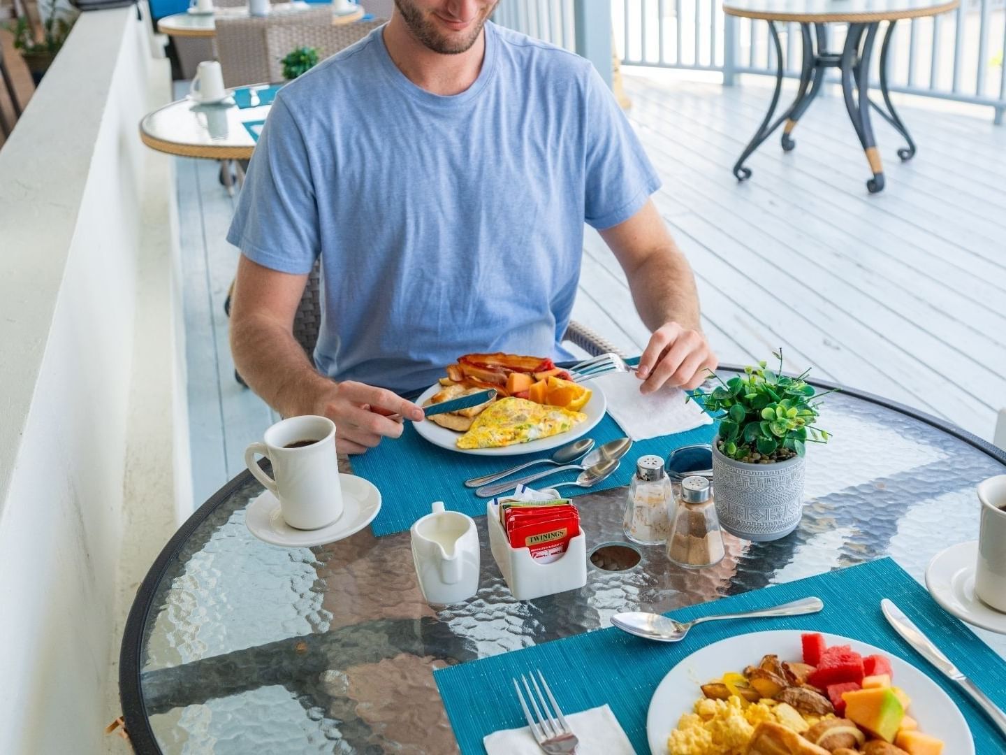 Man enjoying a breakfast on the porch at Savannah Beach Hotel.