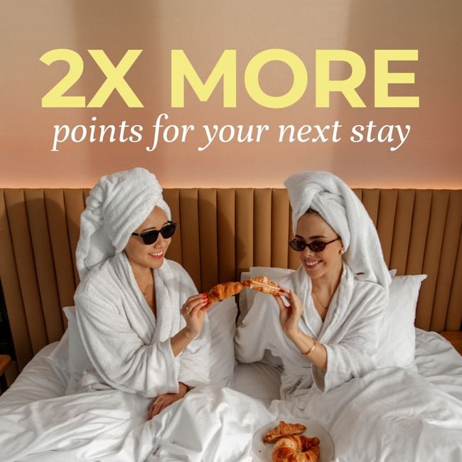 Two guests eating breakfast ib bed