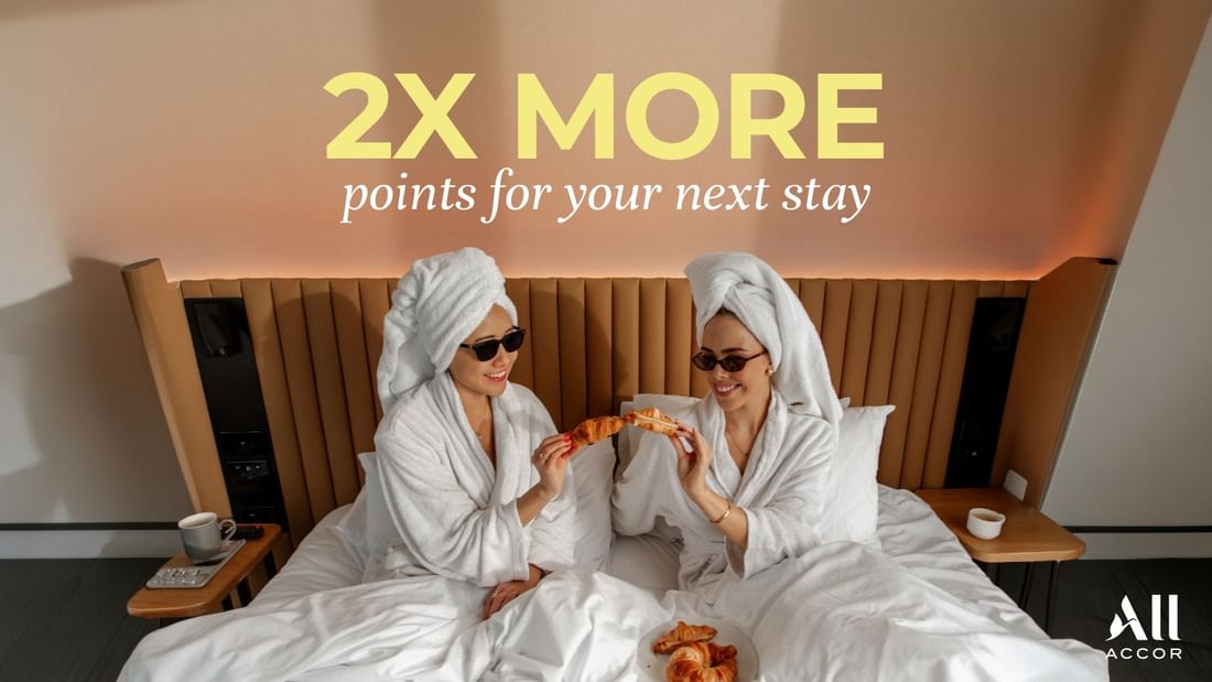 Two guests eating breakfast ib bed