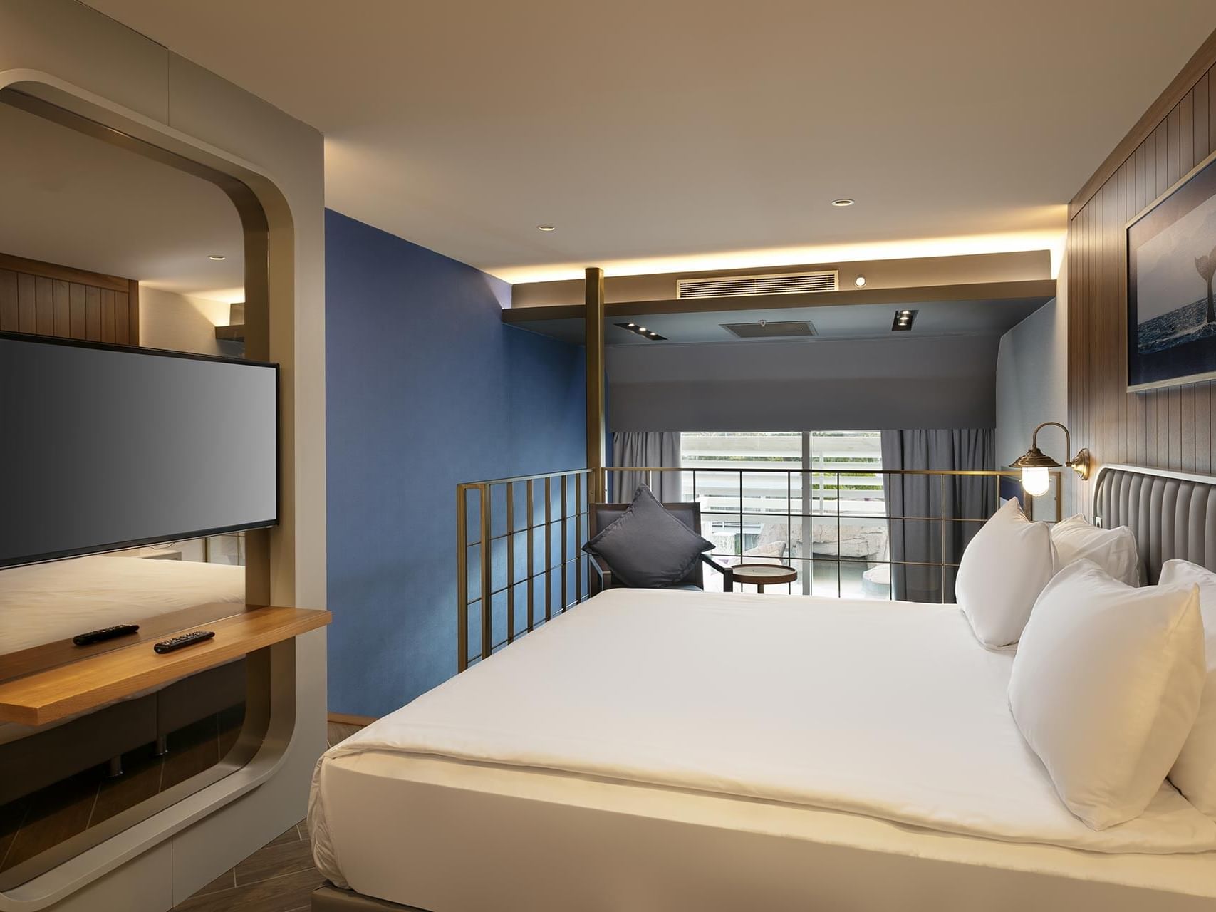 French bed and a single sofa with a large TV in Duplex Suite at Titanic Deluxe Lara