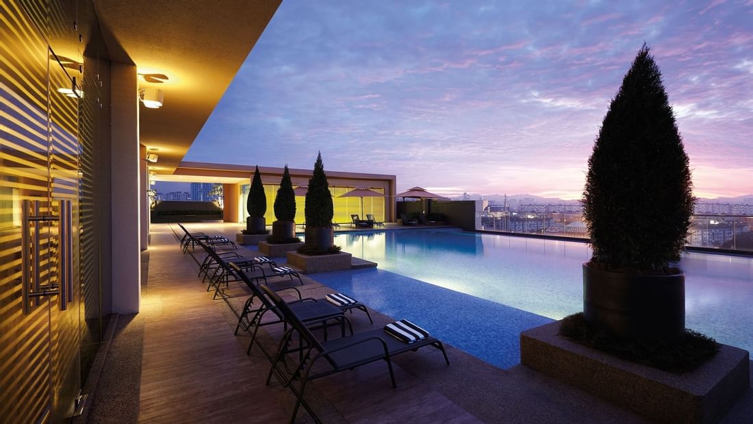 Sunbeds by the infinity pool at night in Sunway Lagoon Hotel