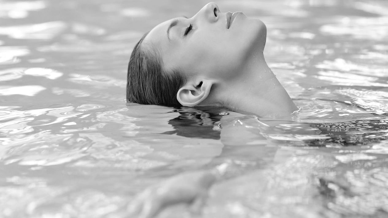 A lady relaxing in the pool at Crown Hotels