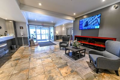 Front desk by lobby lounge area at Service Plus Inns & Suites Grande Prairie