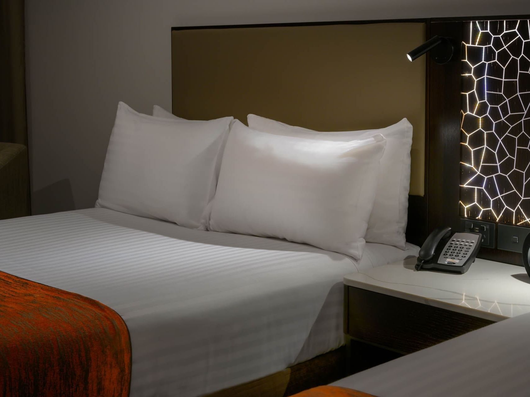 Telephone by a comfy double bed in a Room at Grand Chancellor Hobart