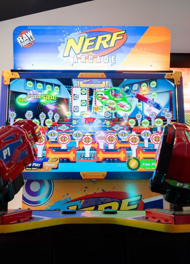 Nerf Arcade shooter game with two blasters mounted below a glowing target screen at Hotel X Toronto