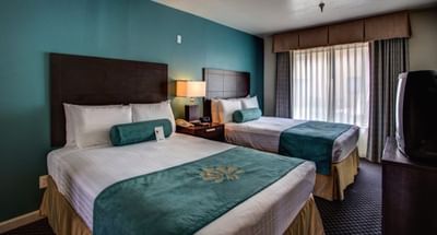 Bedroom suite with dual double beds at the Alexis Park Resort 