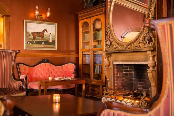 Fireplace & sofas in Side Room Parlour at The Inn at Saratoga