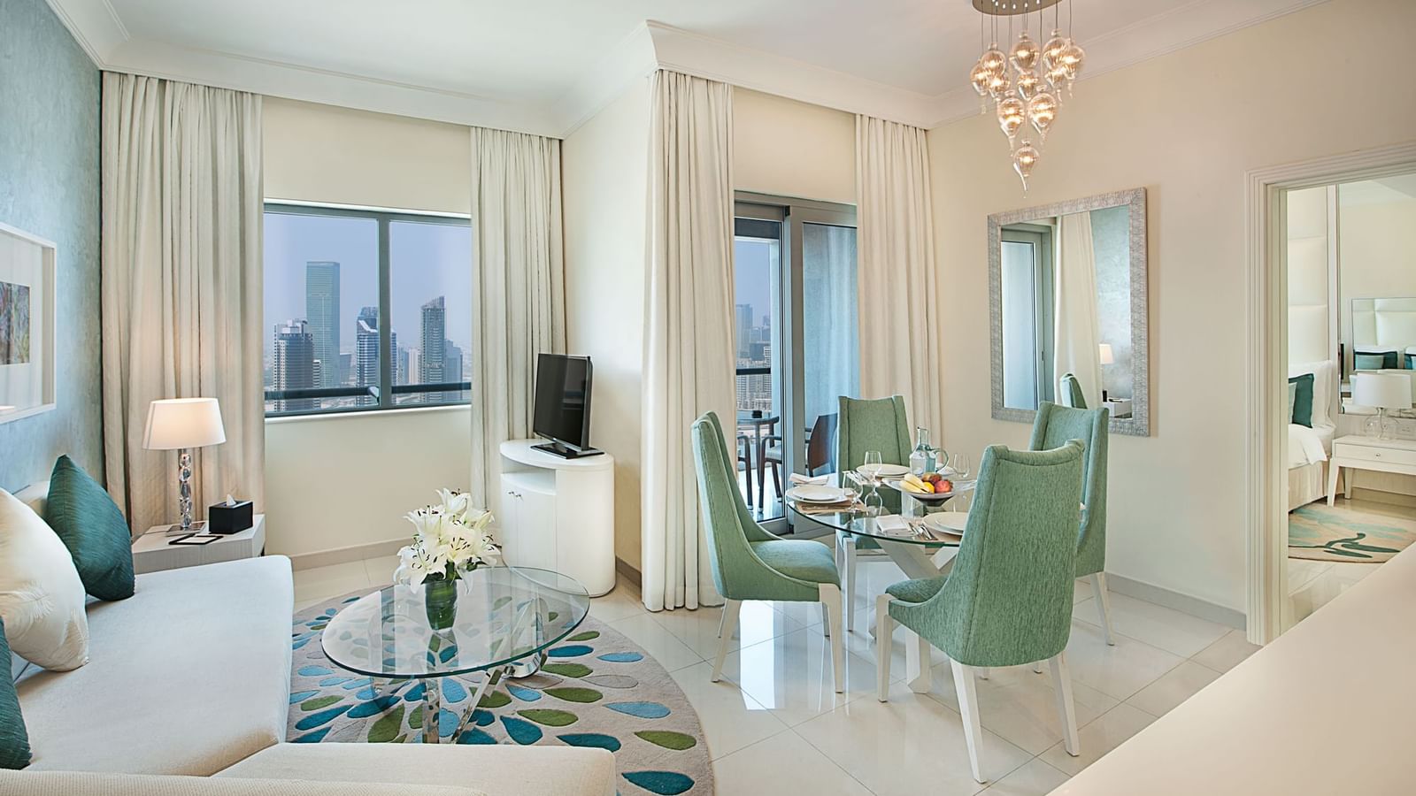 Living area with a dining and cityscape view in One Bedroom Suite at DAMAC Maison Mall Street