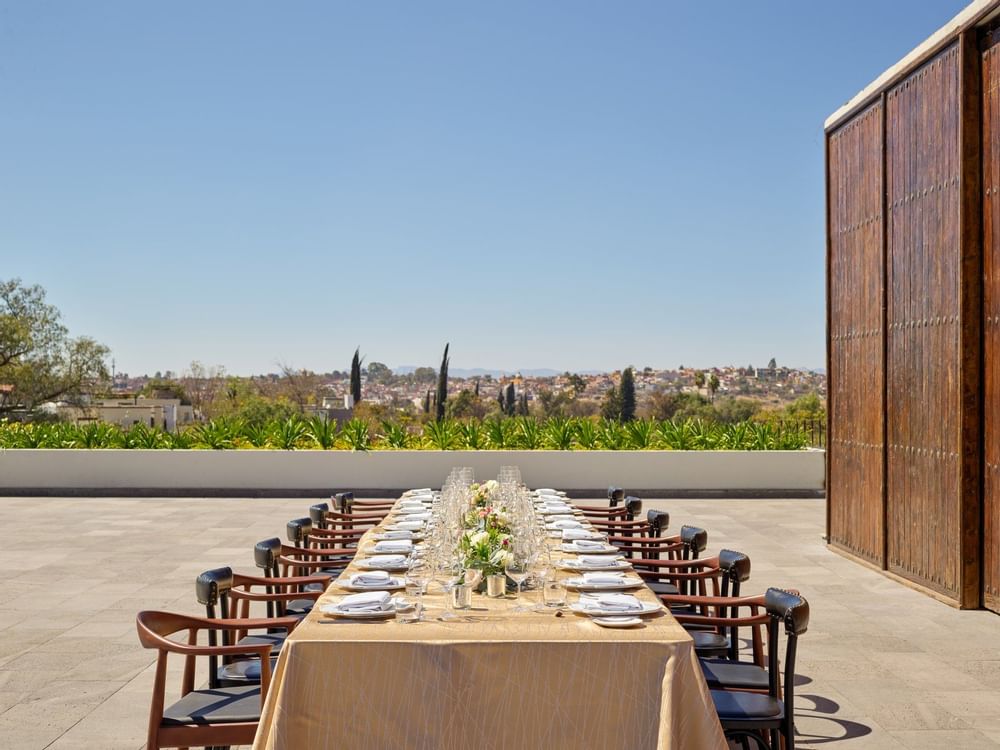 An outdoor boardroom table setup by exterior view at GFA hotels